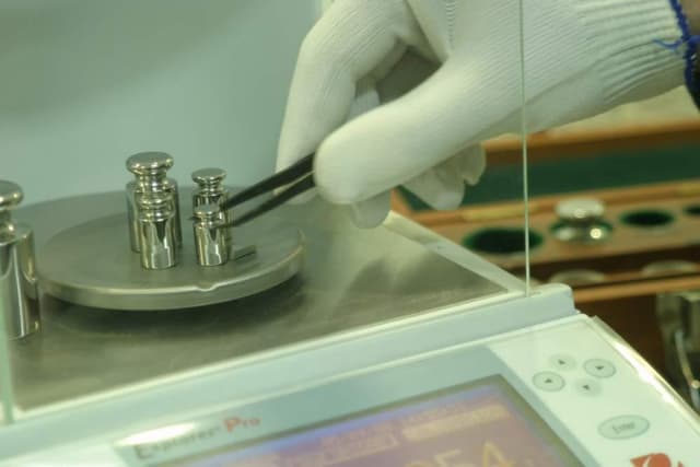 Two each of gray, white, and black shirts laying flat.